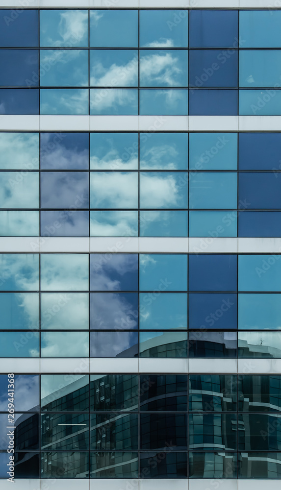 blue glass building facade with sky reflection blue glass building facade with sky reflection