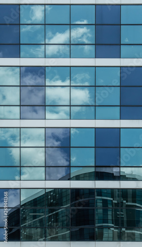 blue glass building facade with sky reflection