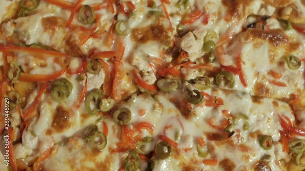 Pizza on a wooden board in a pizzeria.