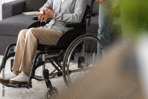 cropped view of man carrying senior mother on wheelchair © LIGHTFIELD STUDIOS