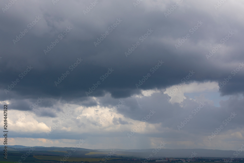 dramatic stormy sky with rain showers