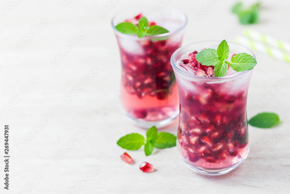Mint pomegranate sparkling infused water. Selective focus, space for text.