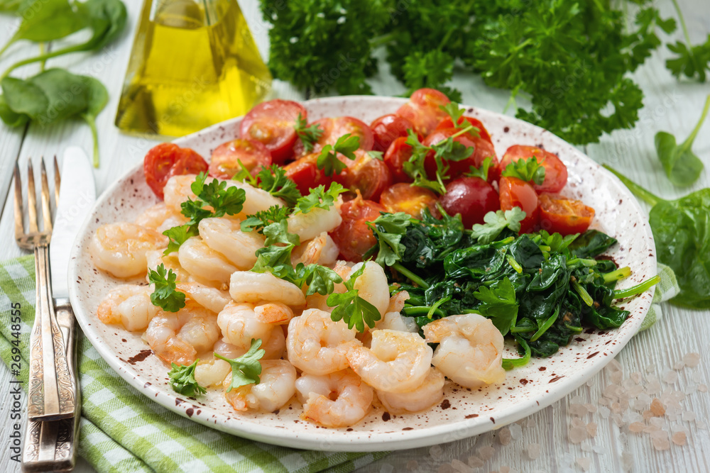 Grilled shrimps and tomatoes with spinach, garlic and parsley. Grilled shrimps and tomatoes with spinach, garlic and parsley.