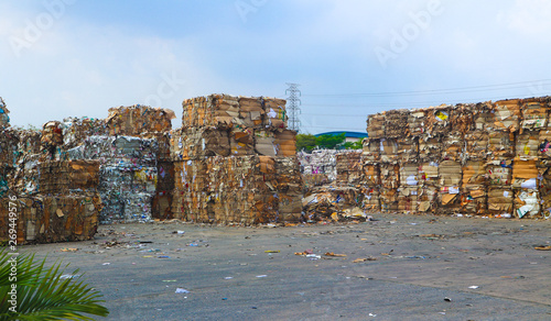 Bangkok/Thailand-May 23,2019:  Thai recycle industry cardboard garbage and paper waste after pressing in hydraulic baling garbage press machine to a square dense for transportation to recycle factory 