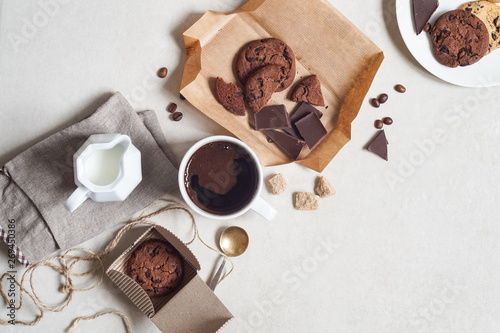 Oatmeal cookies with cocoa and chocolate, cup of coffee and a milk jug © natagolubnycha