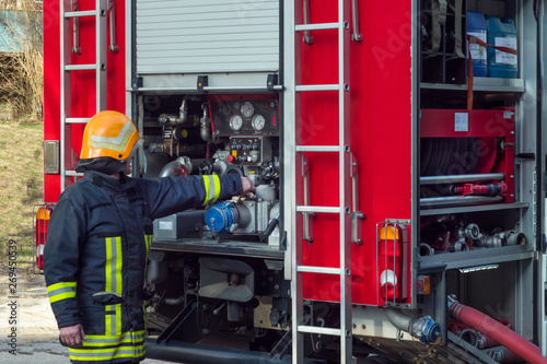 fireman work with firetruck equipment