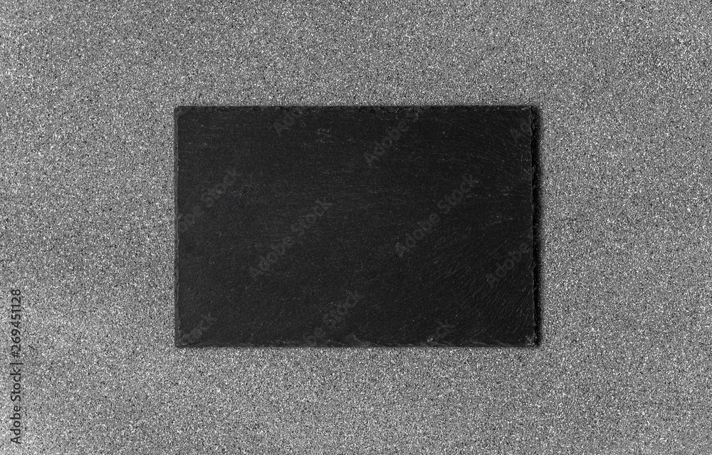 Fototapeta premium Background of grey stone texture and pattern with black slate piece for food and product photography