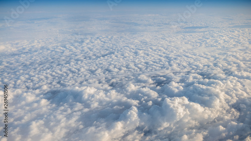 The beautiful cloudscape with clear blue sky. A view from airplane window.