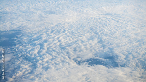 The beautiful cloudscape with clear blue sky. A view from airplane window.