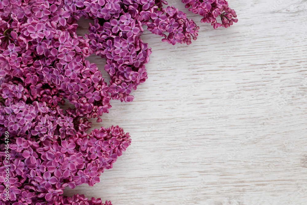 Background of lilac flowers on a wooden surface
