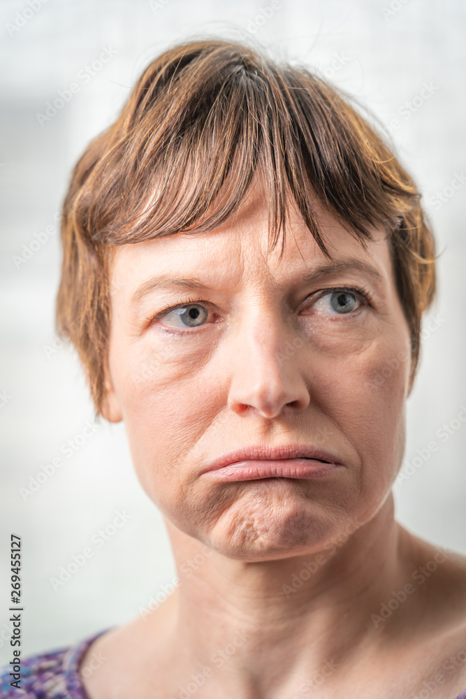 Fototapeta premium Paris, France - 05 19 2019: Studio photo session with my girlfriend. Woman with bad expressive face
