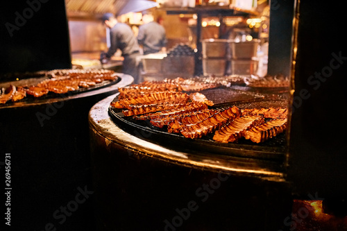Spare ribs cooking on barbecue grill at restaraunt or food festival strret food photo