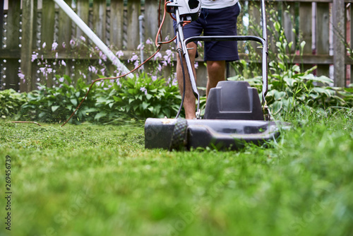 Obraz na plátně The lawn mower is old in a private house, mowing the grass, appliances, mowing,