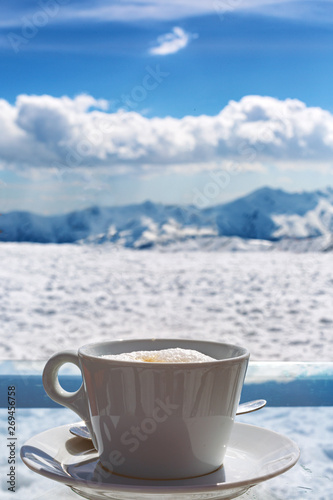 Cup of coffee on the background of mountains. Sky, clouds, nature, the holidays in Georgia.