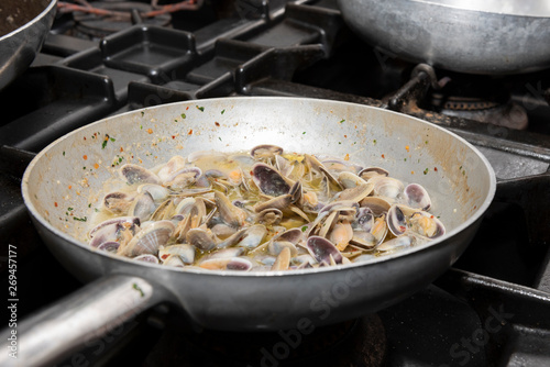 cook in the pan a very good dish of telline, typical Italian food photo