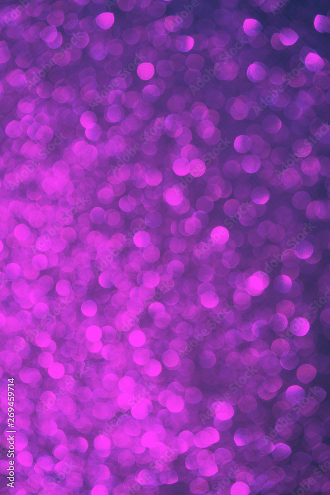 Blurred bokeh dark violet purple and black background, Christmas and New Year party holidays concept. Festive holiday card bright backdrop. Defocused. Flat lay, top view, copy space.