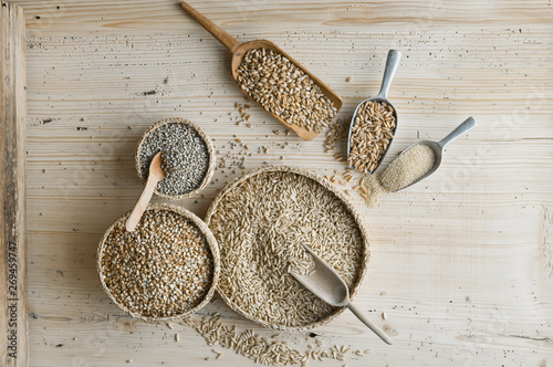 Organic wheat, rye shot, amaranth, spelt, buckwheat and oat on shovels and on wood, from above photo