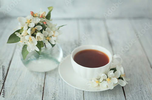 cup with tea on a white textural wooden square background