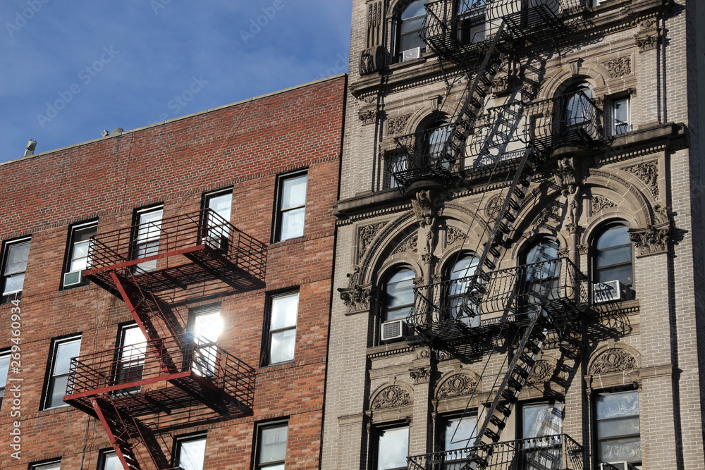 fire ladder of Harlem buildings in sunny day