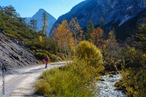 Austria, Tyrol, Karwendel mountains, Hinterautal, woman hiking along River Isar photo