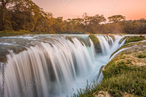 Amazing sunset over the turquoise waterfalls at Las Nubes in Chiapas, Mexico photo