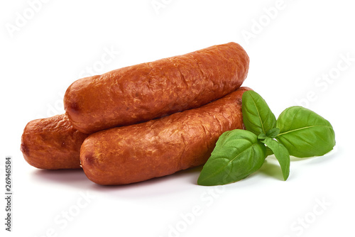 Bavarian Smoked Sausages with basil leaves, dry meat, close-up, isolated on white background