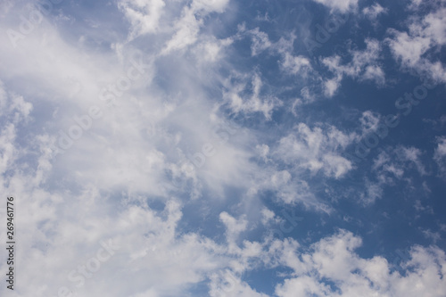 Fototapeta Naklejka Na Ścianę i Meble -  Spindrift clouds of good weather on blue sky. Fantastic skies on the planet earth. The sun is hidden.