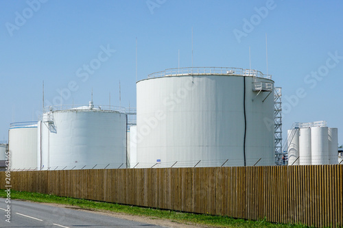 white cylindrical storage tanks for petroleum products © Zigmunds