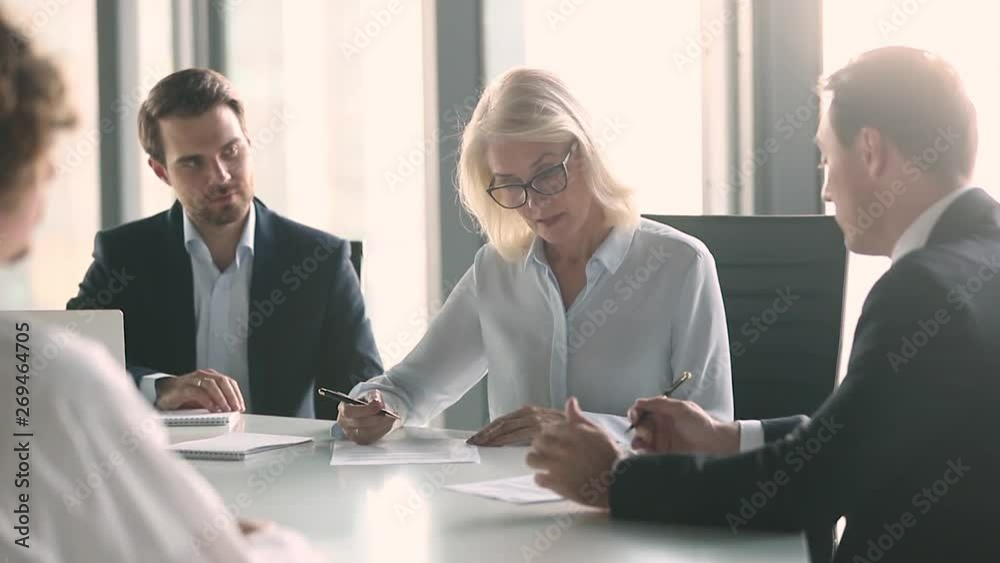 Business partners negotiate sign contract handshake at group meeting