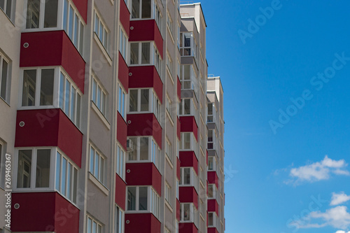 pink house with red balconies close-up against the blue sky