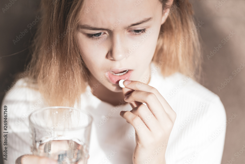 medicine, health care and people concept - close up of woman taking in pill