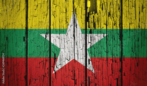 Flag of Myanmar (also known as Burma), wooden background, dirty.