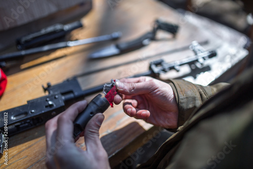 male person soldier cleans the weapon, disassemble, make maintenance of service weapon