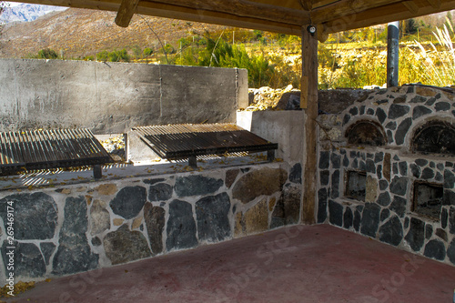 the grill in open air. two grills low wooden roof 