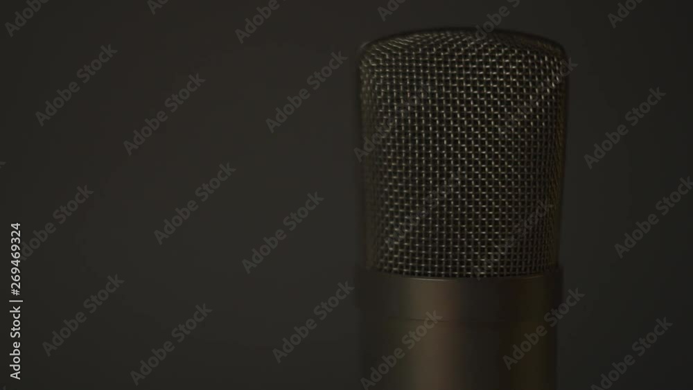 Podcast voice over large diaphragm microphone, rotating close up shot