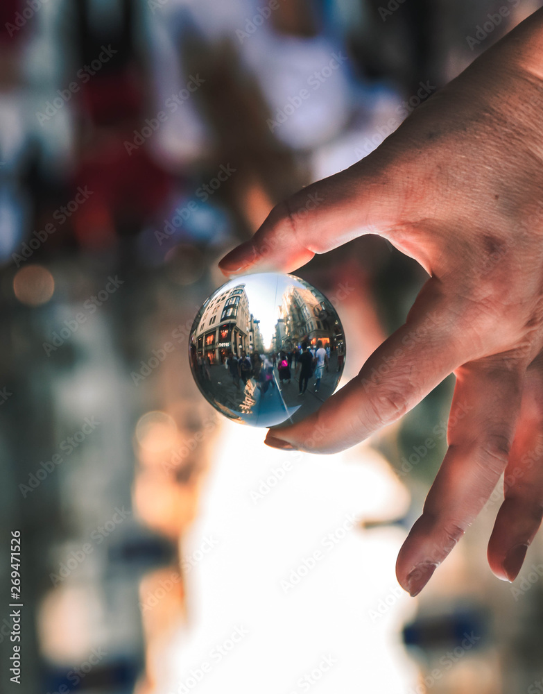 Fototapeta premium lensball on hand in the streets of the city.