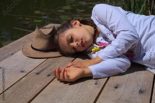 beautiful, cute little girl resting in nature