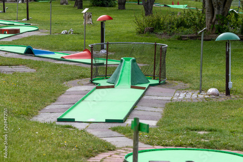 View over a minigolf area with green grass in summer