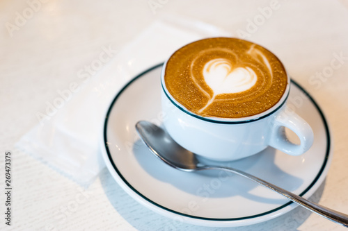 Takadanobaba, Japan, 03/23/2019 , Macchiato coffee, with a heart decoration on top with the creamy silky milk, on an italian restaurant. photo