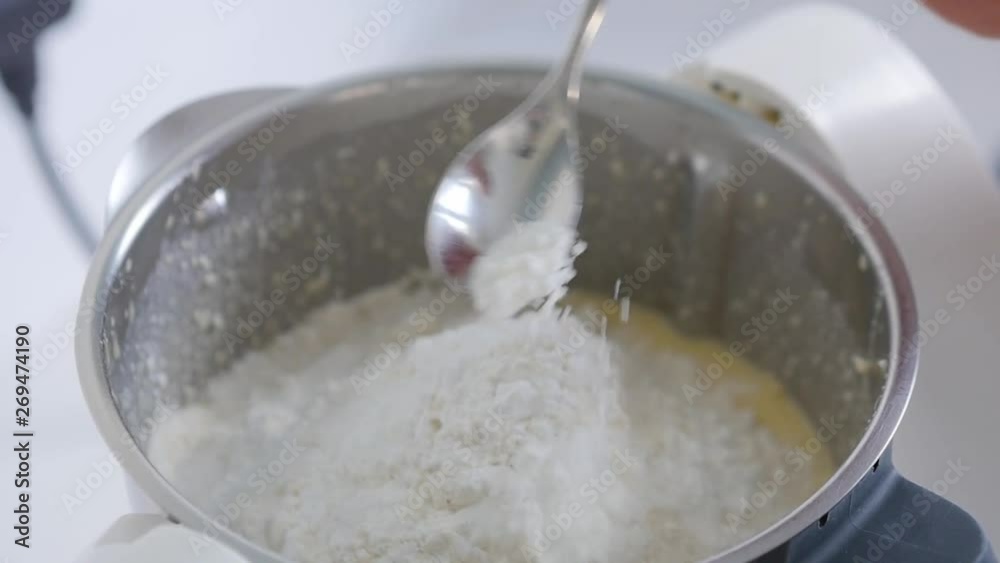 Close-up of adding a spoonful of baking powder to a recipe while cooking Close-up of adding a spoonful of baking powder to a recipe while cooking