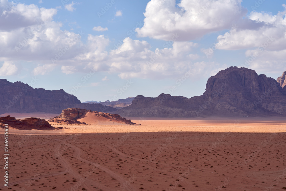 Panoramic view to the landscape of the Wadi Rum desert with red sand dunes and rocks in Jordan. 