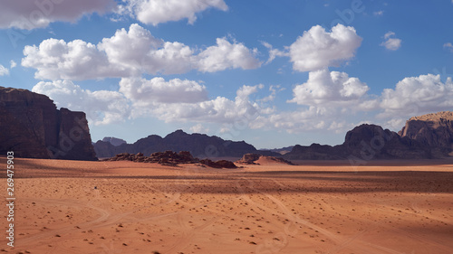 Panoramic view to the landscape of the Wadi Rum desert with red sand dunes and rocks in Jordan. 