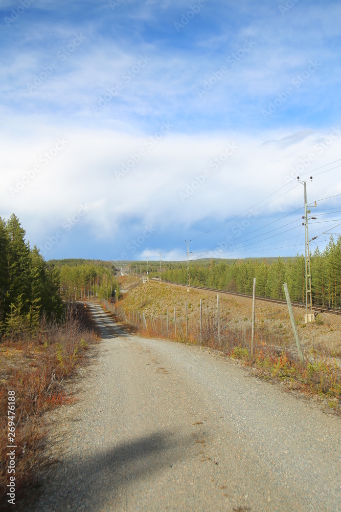 Road besides railroad track in Lapland, Sweden