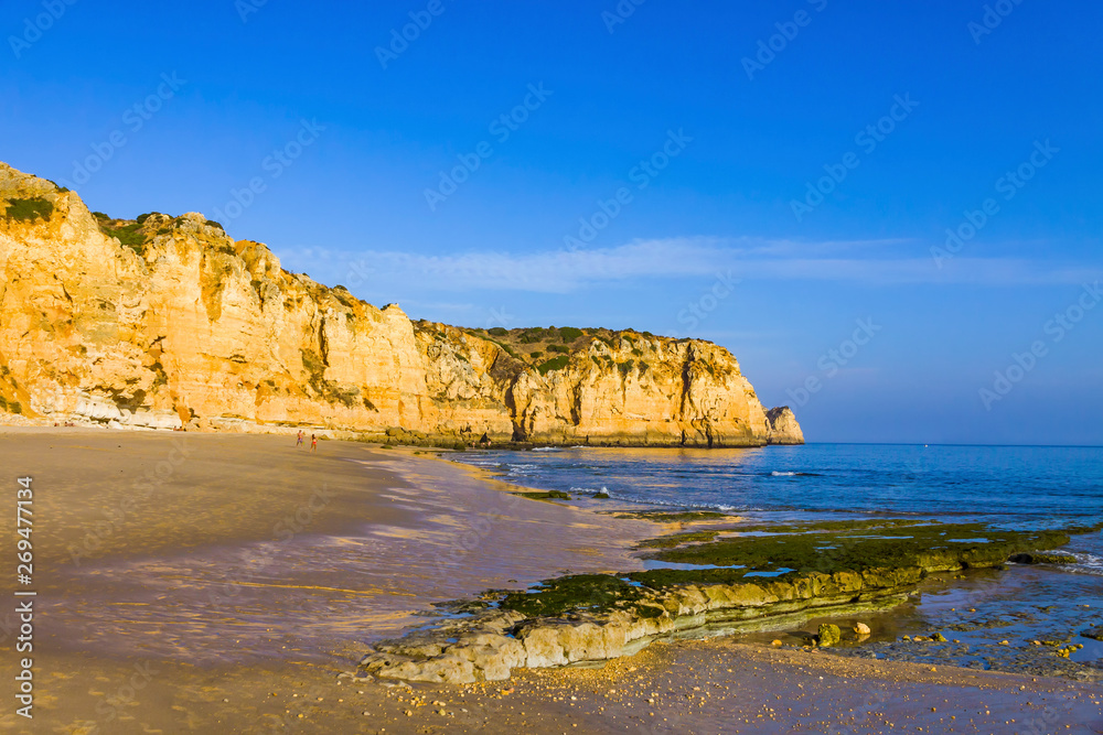 Praia do Porto de Mos, long beach in Lagos, Algarve region, Portugal. Beautiful golden beach, surrounded by impressive rock formations. Favourite spot for surfers and locals
