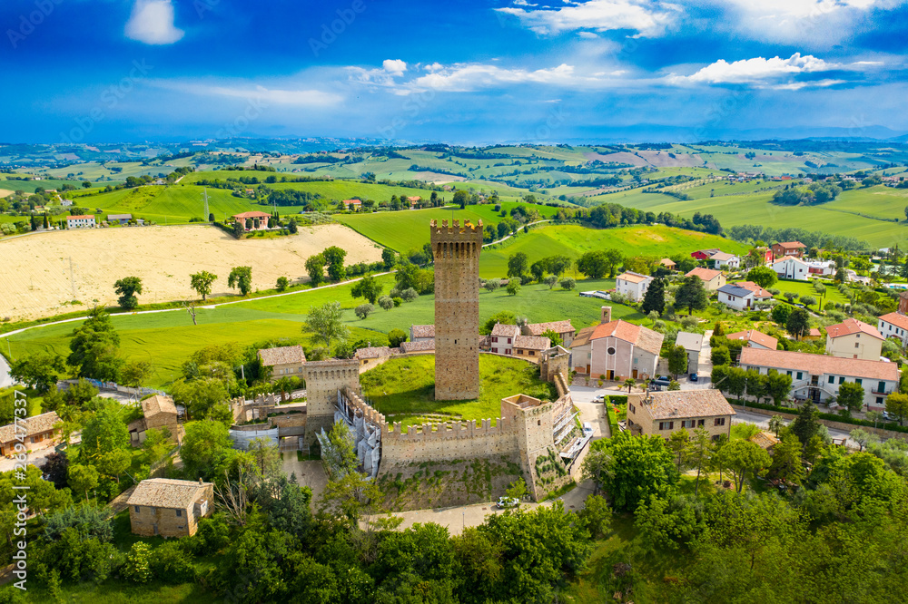 drone view of the 13th century tower of Montefiore Marche hills, in Italy