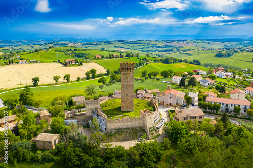 drone view of the 13th century tower of Montefiore Marche hills, in Italy
