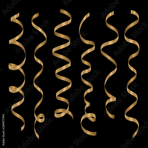Gold curling ribbons or party serpentine isolated on black background.