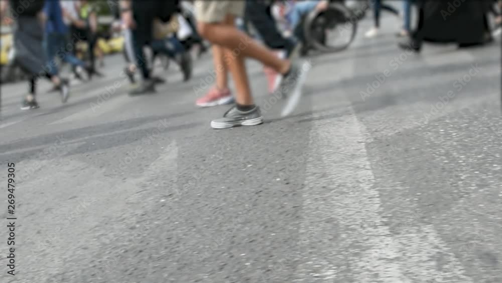 pedestrians crossing the street on a spring day in the city of Athens pedestrians crossing the street on a spring day in the city of Athens