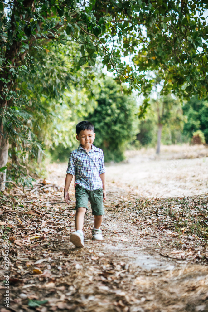 Happy boy playing alone in the park Happy boy playing alone in the park