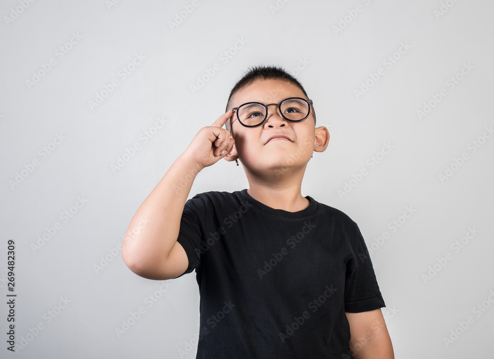 Funny Genius boy Thinking in studio shot Funny Genius boy Thinking in studio shot